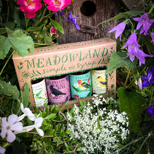 Meadowland simple syrup set in a box surrounded by flowers and greenery